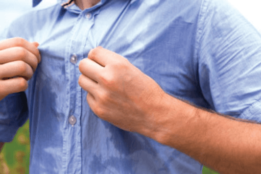 Man in shirt sweating profusely