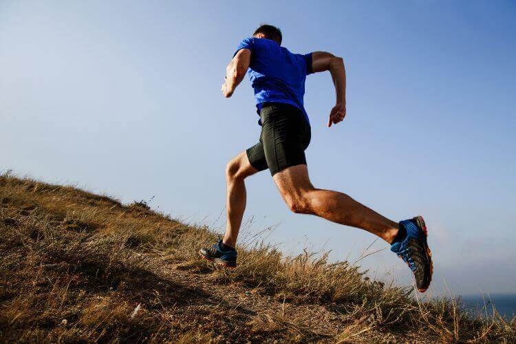 A lone man running on a plain in the middle of nowhere